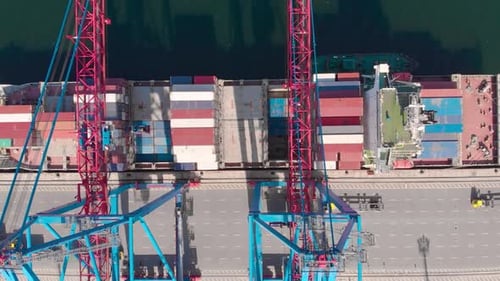 Drone Flying Over a Container Ship During Cargo Operations Over the Customs Area