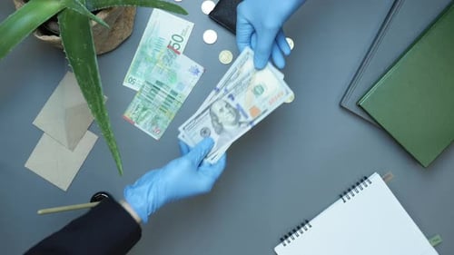 Businessman giving cash money to partner