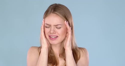 Woman Massaging Temples in Pain Close Up