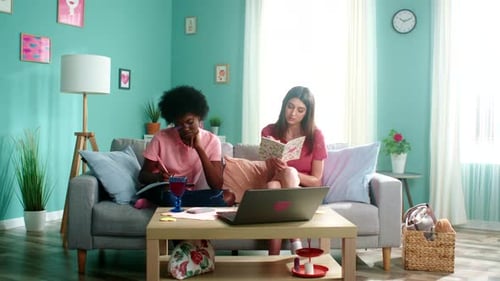 Friends Studying Together on Couch Indoors