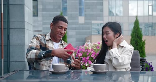 Man Gives Red Gift Box to Girlfriend