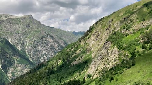 Green Mountains and Valleys Under a Cloudy Sky