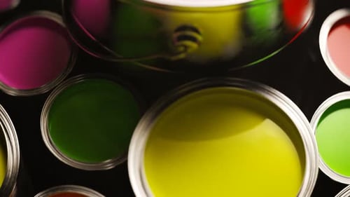 Vibrant Paint Cans Rotating in Colorful Arrangement