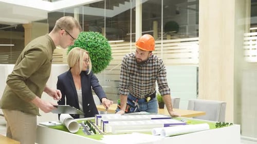 Three Architects Engineers Coworking Modern Office Inspecting 3d Model Building