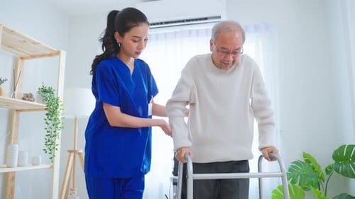 Asian senior elderly man patient doing physical therapy with caregiver.