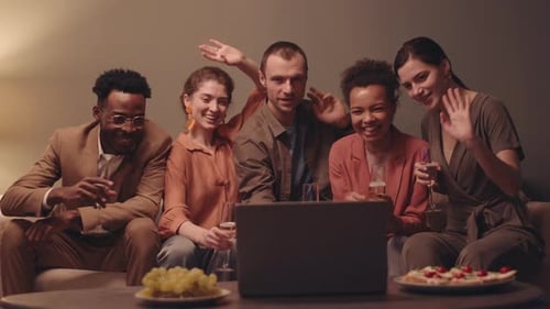 Friends Video Chatting and Waving on Laptop