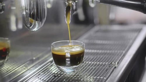 Espresso Poured into Cup From Coffee Machine