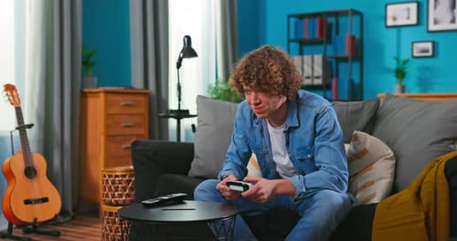 Teenager Playing Video Game on Couch at Home