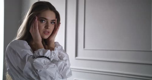 Attractive Woman Posing in White Ruffled Top