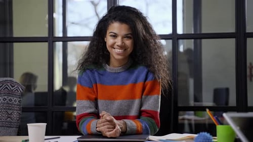 Pretty Mixed Race Woman Posing on Camera in Office