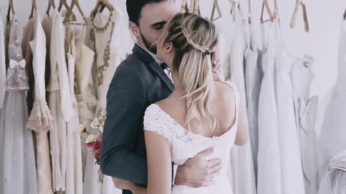 Romantic Couple Dancing in Bridal Dress Boutique