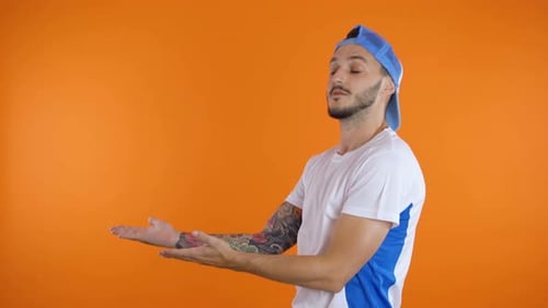 Man Presenting on Orange Background