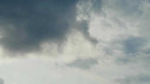 Dramatic Clouds Rolling Across a Light Blue Sky