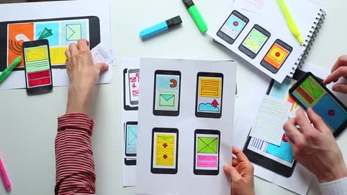 Designers Sketching Mobile App Interfaces on Paper