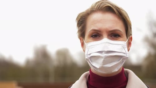 Blonde Woman Wearing Surgical Mask Outside