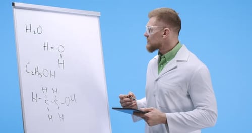 Man Explaining Science Formulas on Whiteboard