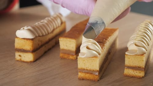 Decorating Individual Cakes with Frosting Close Up