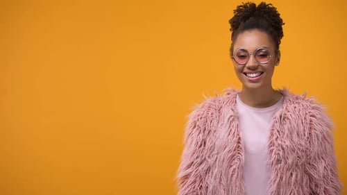 Smiling Woman Posing in a Pink Fur Coat