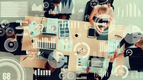 Overhead View of Business Meeting with Data Graphics