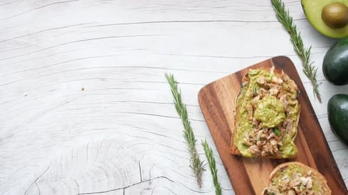 Avocado Toast Topped on Bread Board With Food