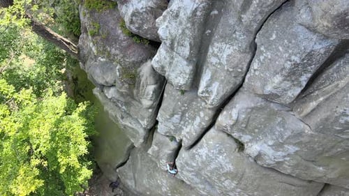 Strong Child Climber Climbing Steep Wall of Rocky Mountain
