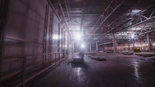 Builders Install Contractions Near Wall in Empty Warehouse