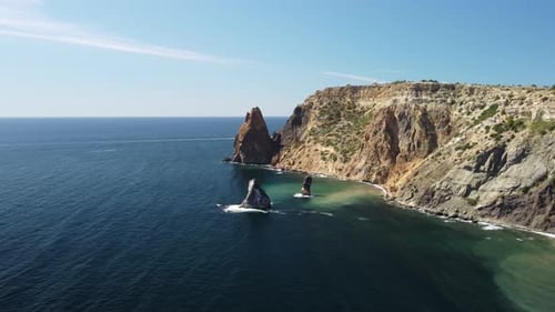 Aerial View From Above on Calm Azure Sea and Volcanic Rocky Shores