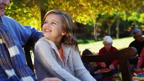 Grandfather and Granddaughter Enjoy Fall Picnic