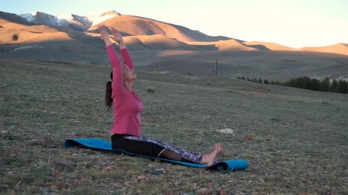 Sporty Woman Doing Yoga in Asian Steppe at Sunset