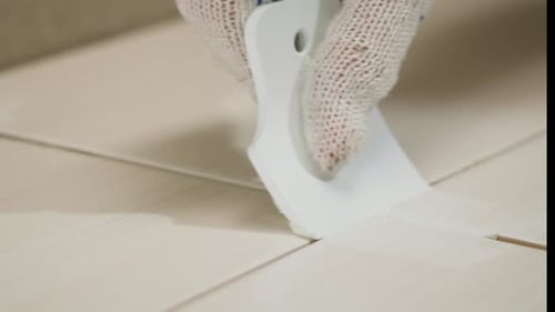 Hand Grouting Tiles in Home