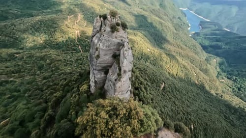 Dynamic Drone Shot Along Rocky Mountain Cliff Turns to a Dive