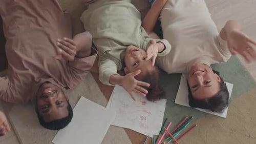 Top View of Happy Family Waving at Camera