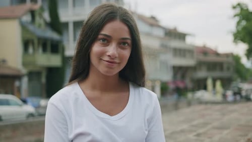 Young Woman Smiling in an Urban Setting