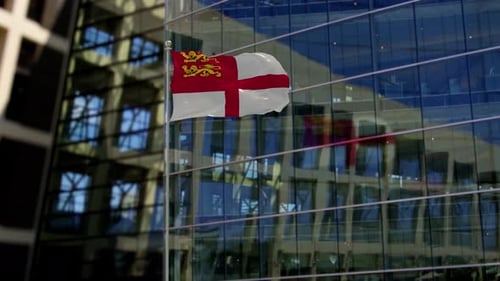 Dunkle Flagge weht auf einem Wolkenkratzer-Gebäude