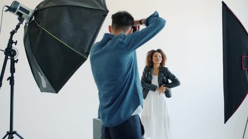 Model Mixed Race Lady and Photographer Working in Studio During Photo Shoot