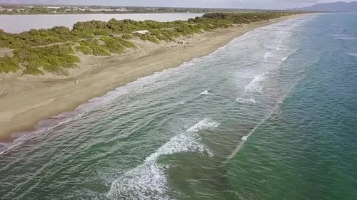 Sandy Beach Spit Washed By the Water on Both Sides. Aerial Survey. Slow Motion