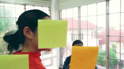 Team Collaborating Using Sticky Notes in Modern Office