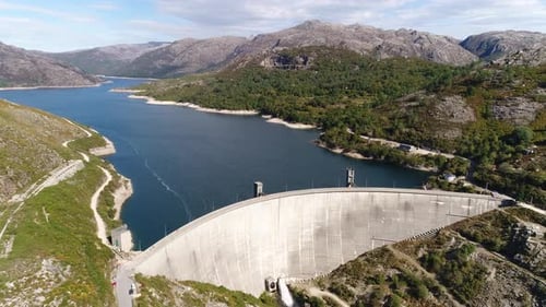 Modern Dam Reservoir on Blue Lake Waters Generate Alternative Energy in Highland Wild Area