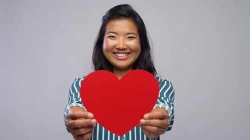 Happy Woman Holds Red Heart Shape