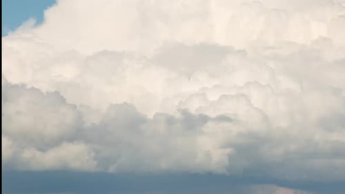 Dramatic Clouds Billow in a Blue Sky Time-Lapse