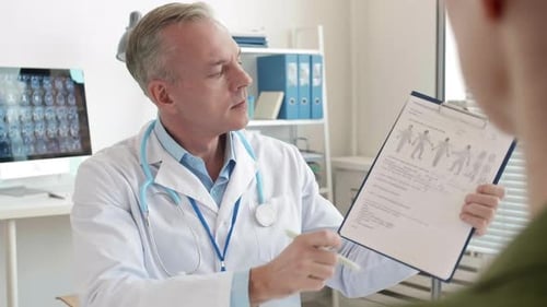 Doctor Explains Patient Chart in Medical Office