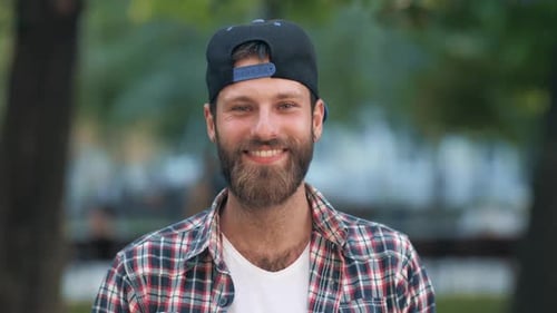 Bearded Man Smiling in a Plaid Shirt
