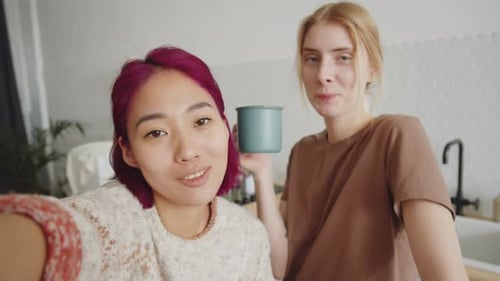 Two Smiling Friends in Modern Kitchen Selfie