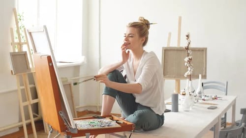 Young Artist Painting in Studio