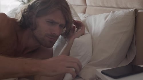 Man Wakes Up and Reaches for Phone