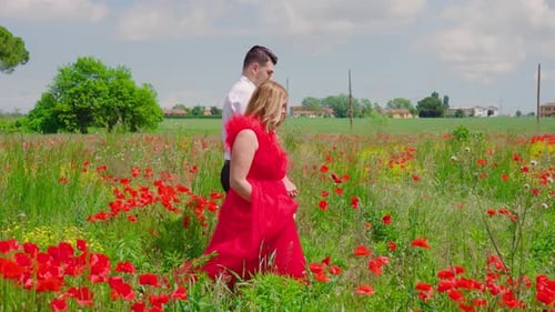 Girl Walks with Boy in the Red Poppy Field