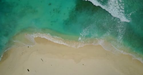 Daytime above clean view of a white paradise beach and turquoise sea background in colorful 4K