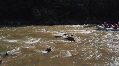 People Kayaking on Mountain River
