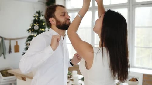 Happy Attractive Young Couple in Love Dance Together in Their Stylish Apartment By the Christmas