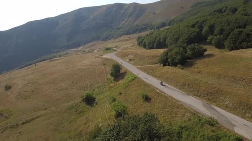 Aerial view of a man driving a motorbike on a mountain road
